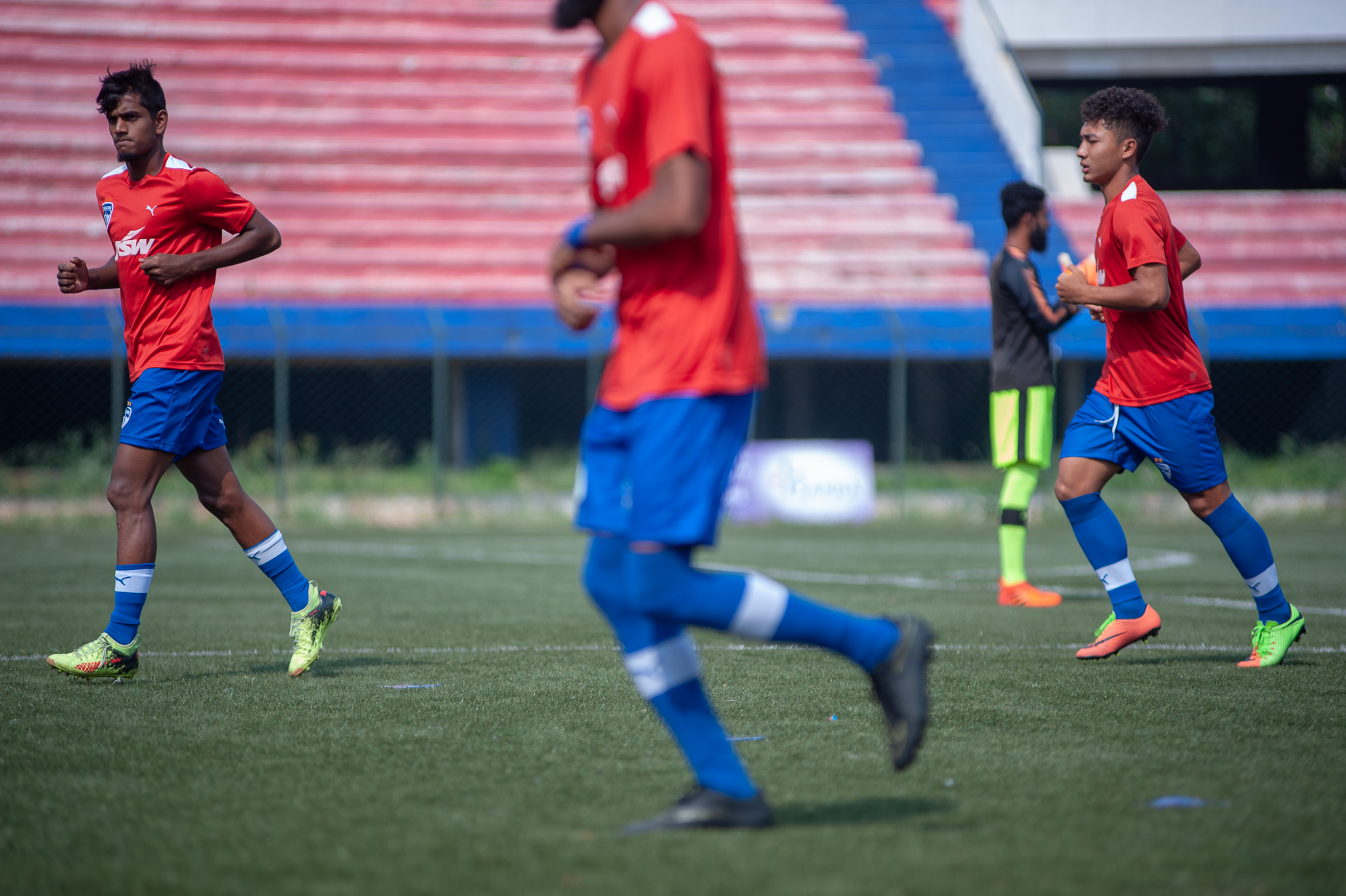 Seen here are three players of the starting XI of Bengaluru FC B warm up before the game.